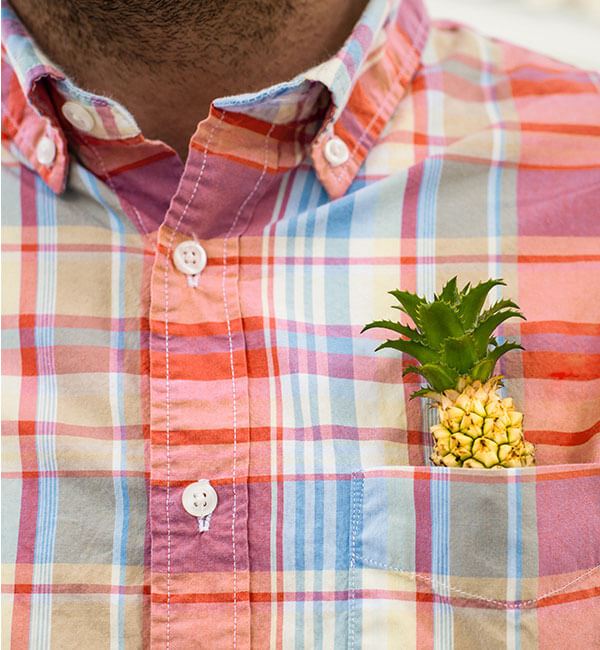 Pineapple in shirt pocket, part of Midtown Nexton identity.